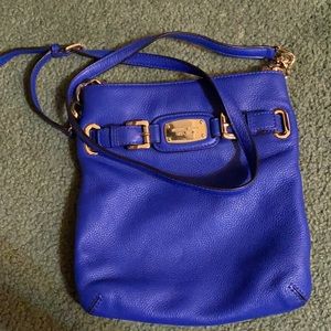Royal Blue Michael Kors Crossbody with gold labeling and strap buckles.